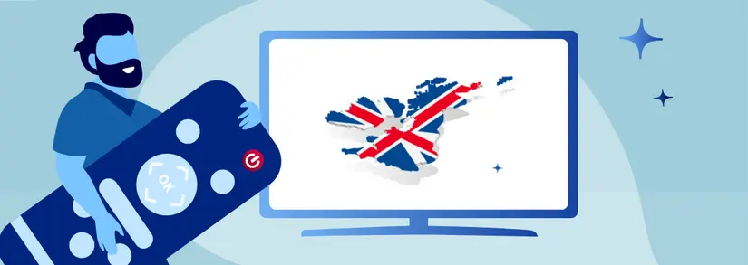 man holding a giant remote control in front of a TV screen with the british flag